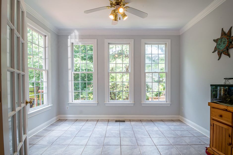 Spacious and bright interior room with large glass windows and tiled floor, perfect for home design inspiration.